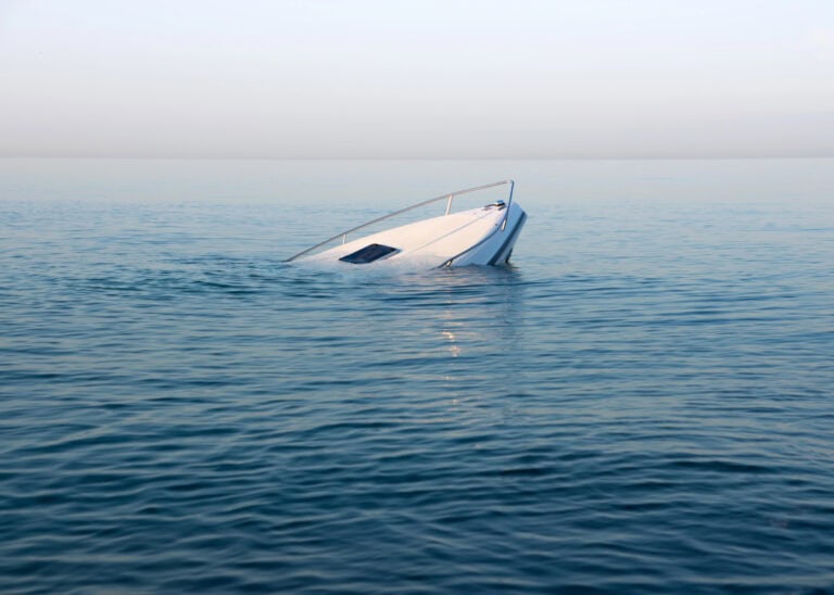 Sinking modern large white boat goes underwater