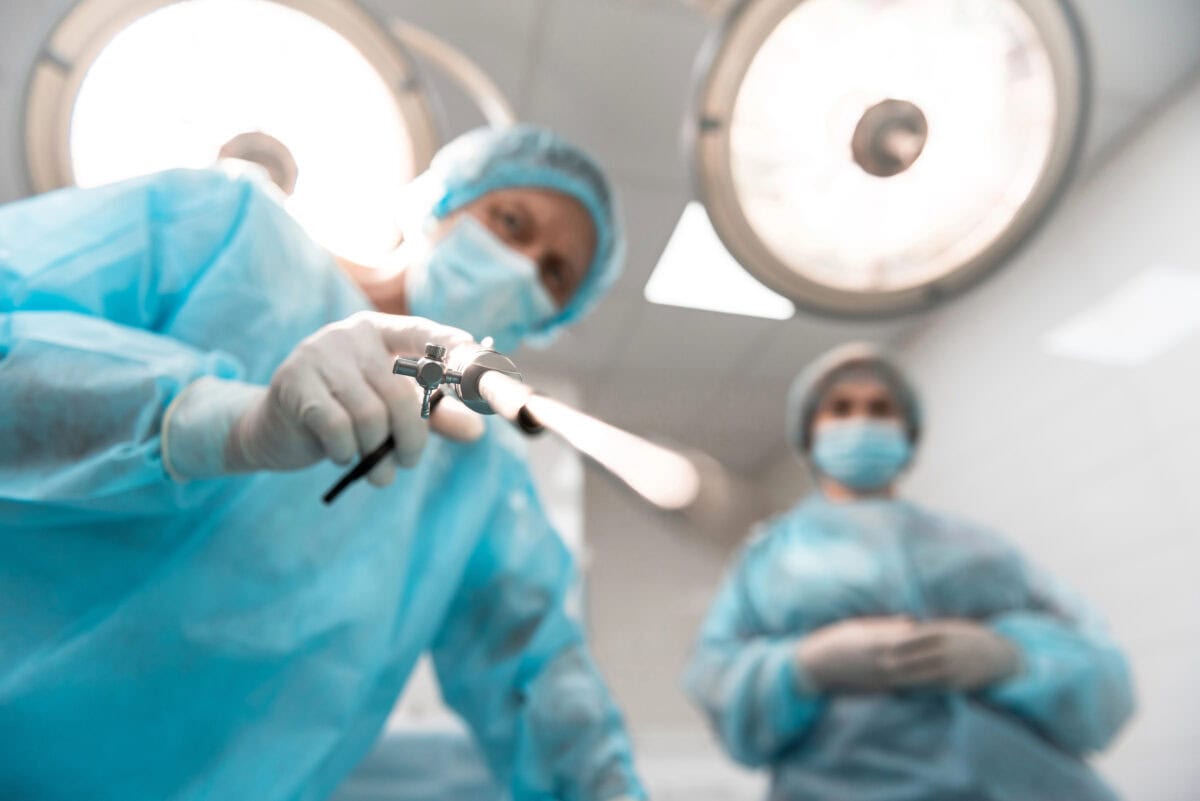 Close up of cystourethroscope in the hands of serious doctor