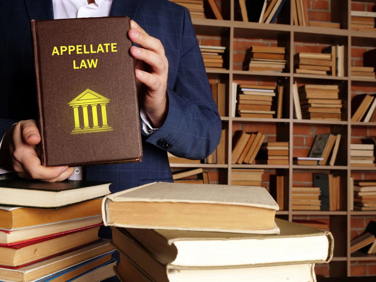 Attorney holds APPELLATE LAW book.